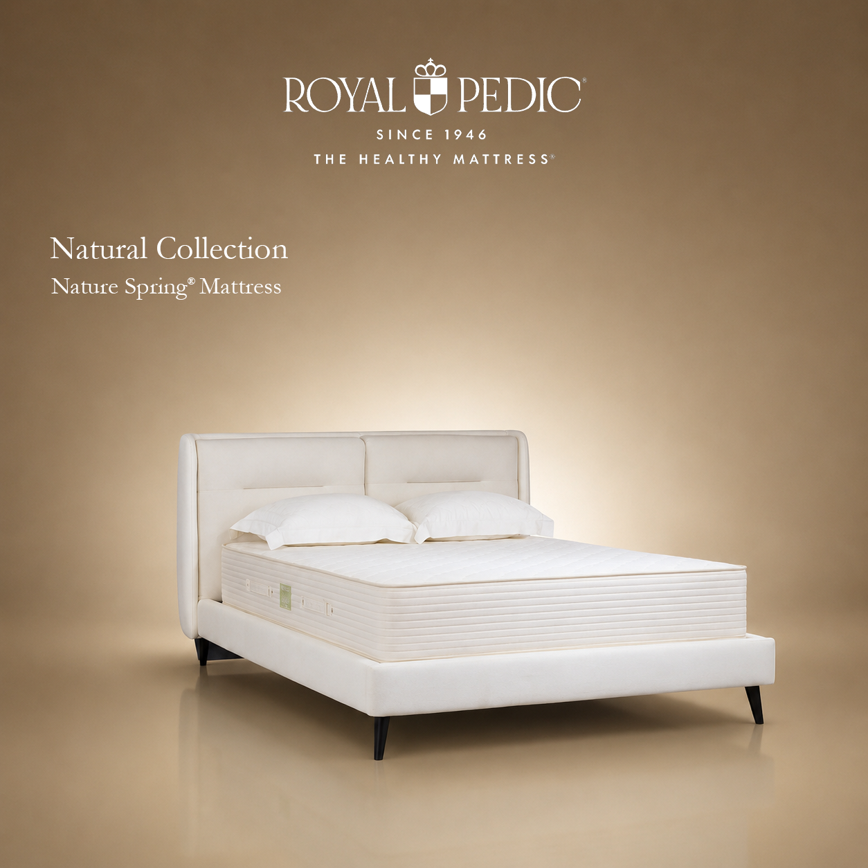 Royal Pedic Nature Spring Mattress on a white upholstered bed frame against a tan background