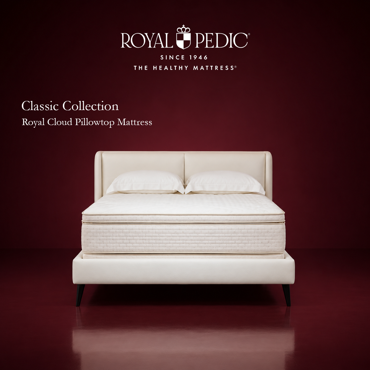 Royal Pedic Royal Cloud Pillowtop Mattress from the Classic Collection on a cream upholstered bed frame against a dark red background