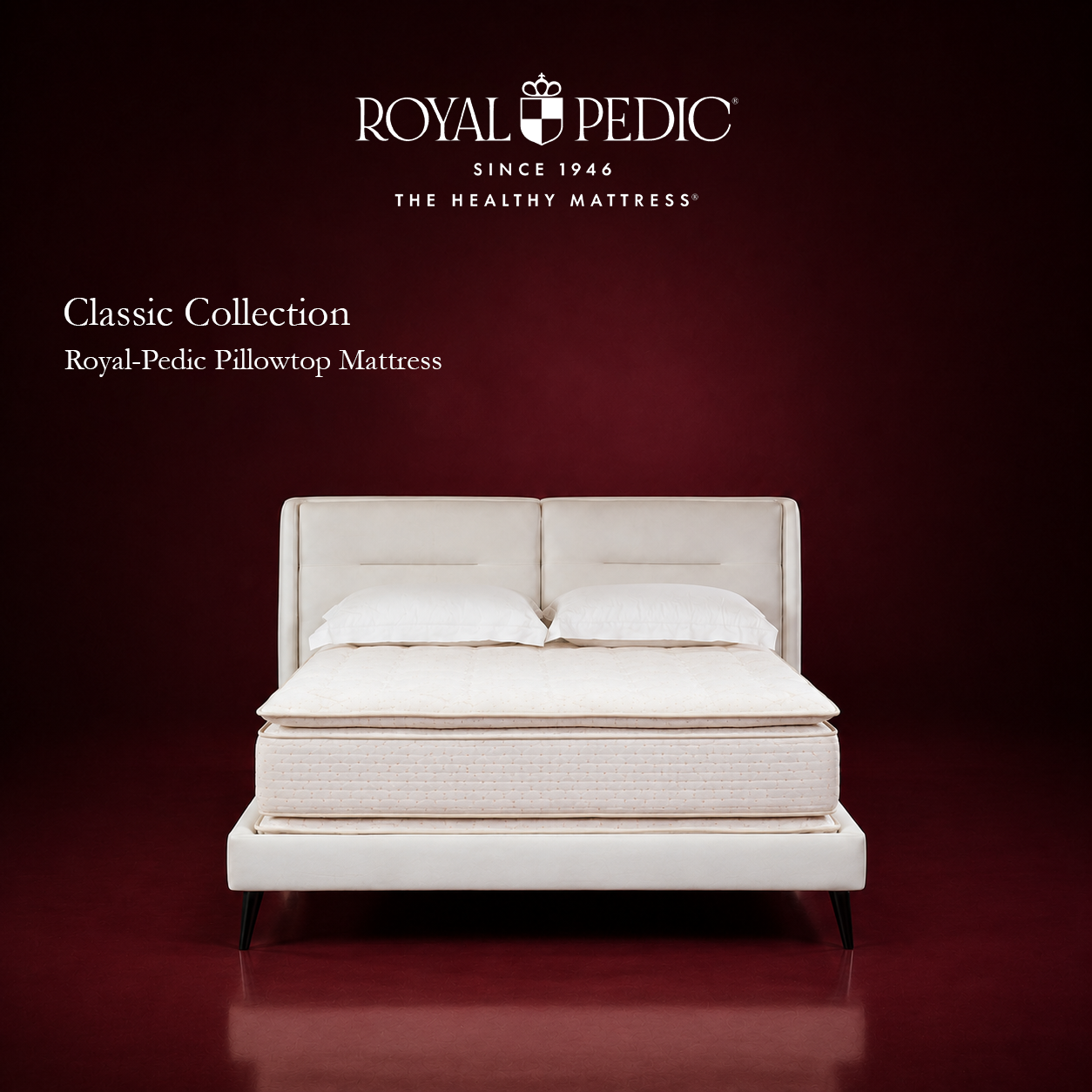 Royal-Pedic Pillowtop Mattress from the Classic Collection on a white bed frame against a dark red background