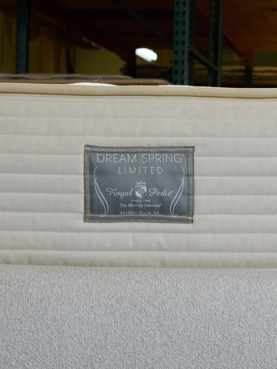 Close-up of the Royal-Pedic Dream Spring Limited Mattress label, featuring the brand name and The Healthy Mattress slogan.