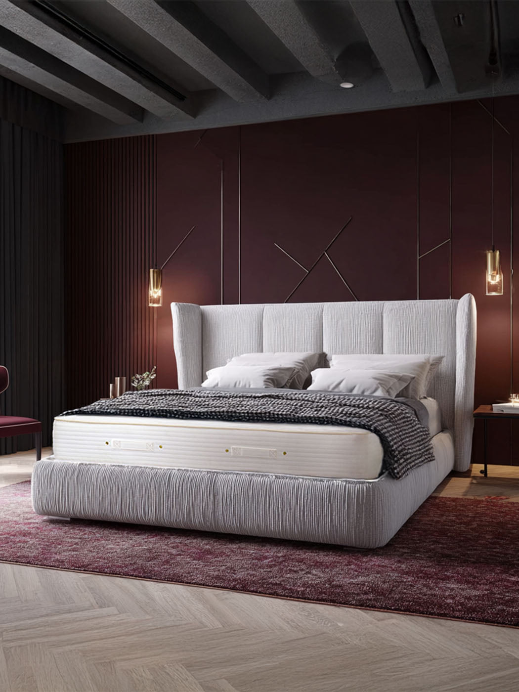 Royal-Pedic Mattress Dream Spring® Limited Mattress on a light grey upholstered bed frame in a modern bedroom with dark red walls.