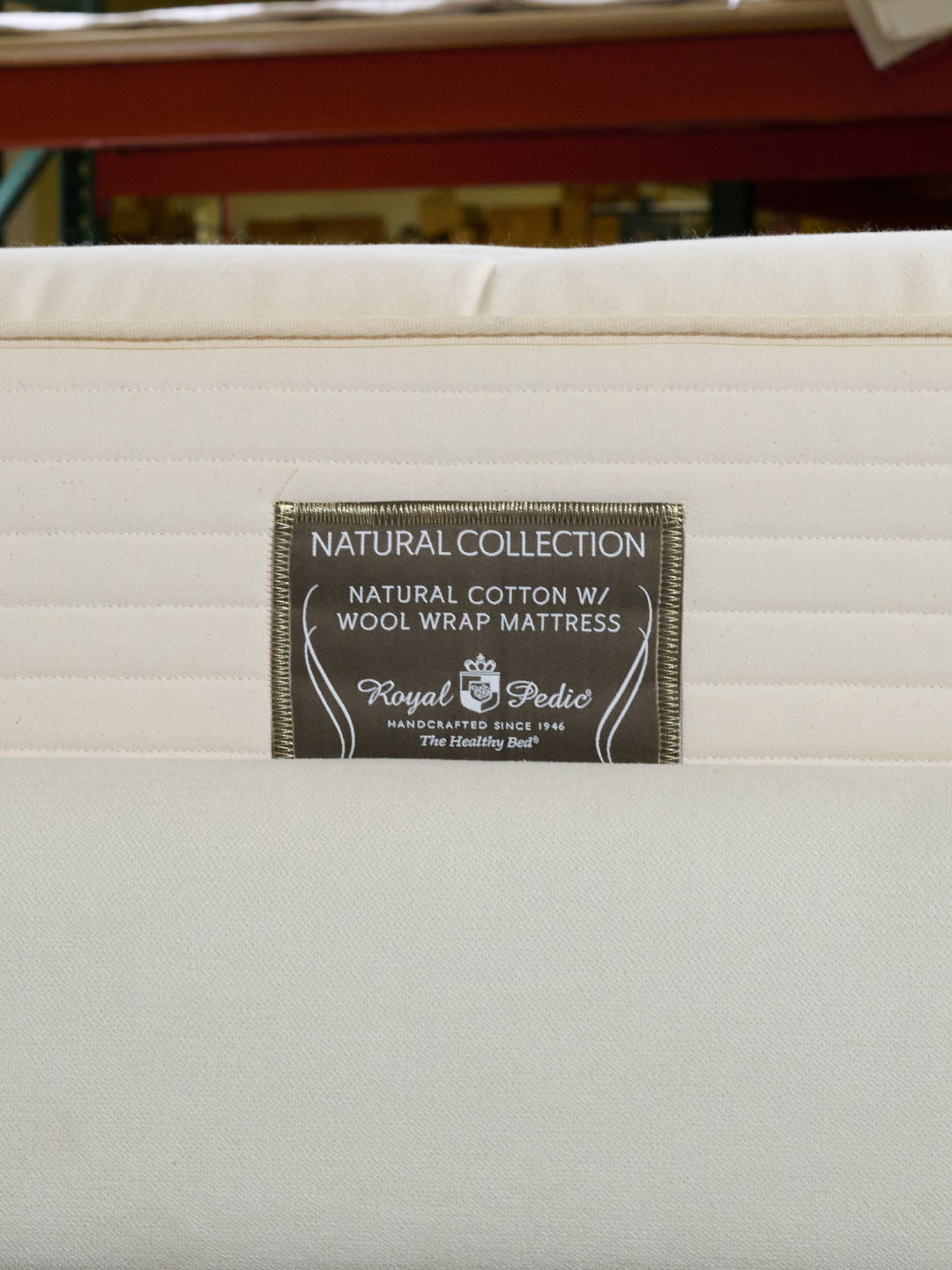 Close-up of the Royal-Pedic Natural Cotton with Wool Wrap Mattress label, showing Natural Collection details.
