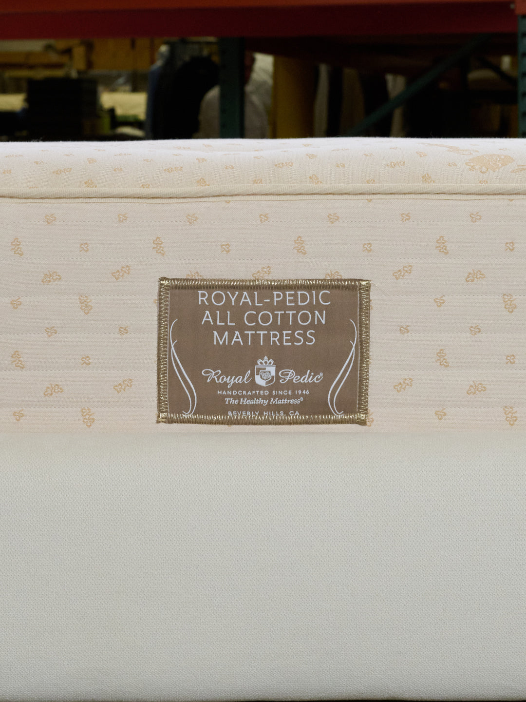 Close-up of the Royal-Pedic all cotton mattress label on a white mattress background